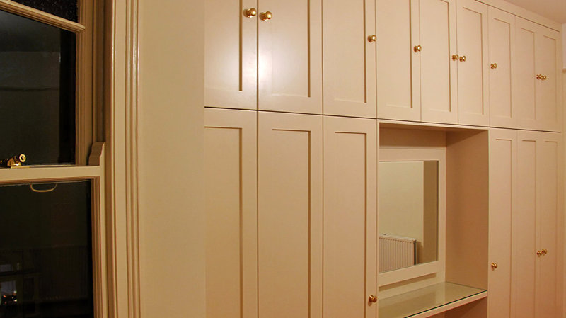Custom made bedroom wardrobes. Satin finished silver birch carcasses with hand painted panel doors. Movement activated lighting. Clapton, London E5 