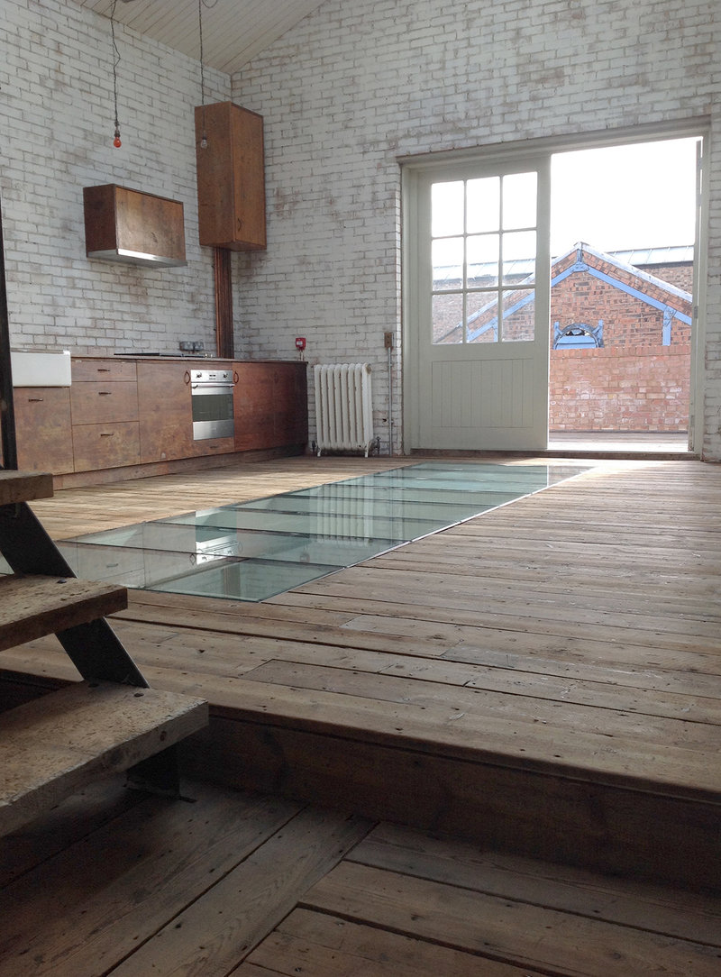 Bespoke kitchen, reclaimed Victorian pine flooring with incorporated glass walk-on panels.  Warehouse conversion. Leyton E10, London 
